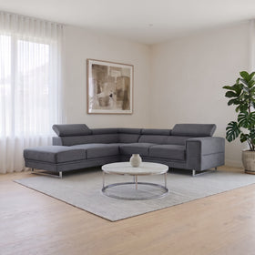 Ascot Sectional Chaise Lounge in Dark Grey with chaise on the right when sitting, adjustable headrests and chrome sled legs, styled in a living room