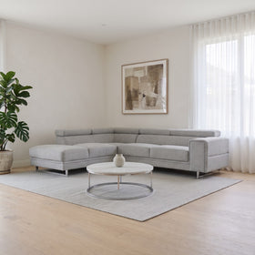 Ascot Sectional Chaise Lounge in Light Grey with chaise on the right when sitting, adjustable headrests and chrome sled legs, styled in a living room