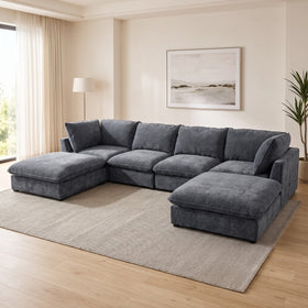 Aspley 6 Piece Modular Lounge in Dark Grey arranged as a U-shape with two ottomans in a bright living room