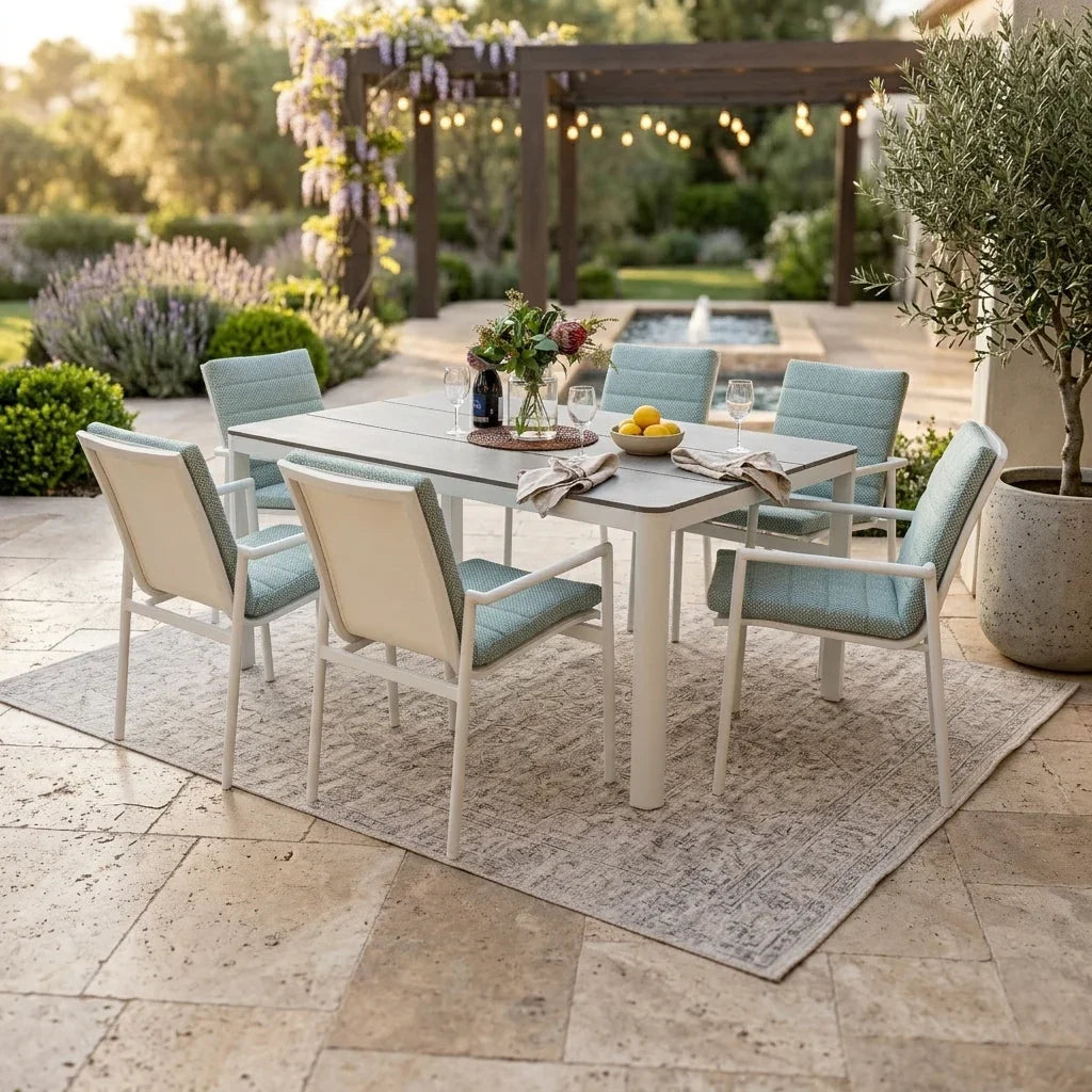 Astra 7 Piece Outdoor Dining Set with white aluminium frame, rectangular table and six chairs on a tiled Queensland patio