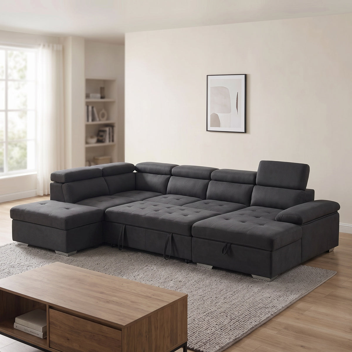 Alex Pull Out Sofa Bed in black fabric, chaise on the right and storage ottoman on the left beside the sofa, with adjustable headrests, in a bright living room