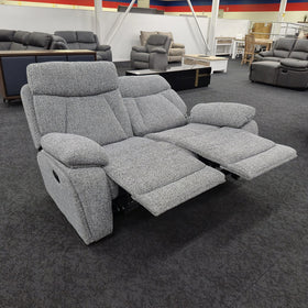 Baker 2 seater recliner lounge in speckled grey fabric in The A2Z Furniture showroom with both footrests extended, showing the reclining mechanism