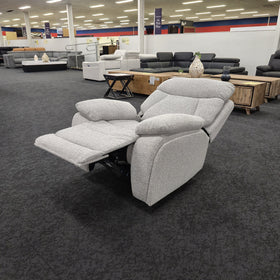 Baker recliner chair in light grey fabric in The A2Z Furniture showroom, fully reclined with the footrest extended and the backrest laid back