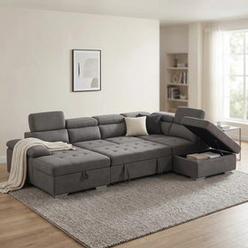 Alex Sofa Bed in grey fabric, side angle with the storage ottoman chaise open and a knit throw draped over the seat