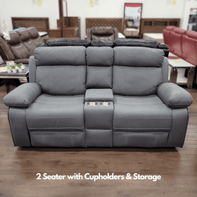 Grey 2 seater recliner lounge with cupholders and storage in showroom setting