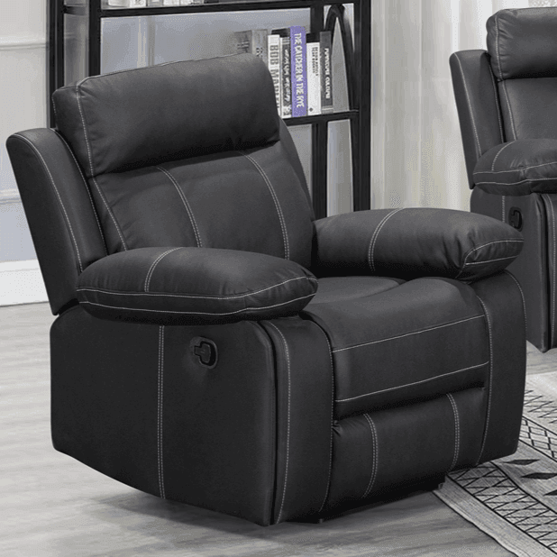Black leather recliner chair with padded armrests and white stitching in a living room