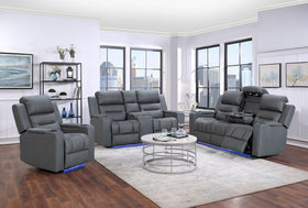 Modern living room with grey electric recliner sofas, armchair, and round coffee table on rug.