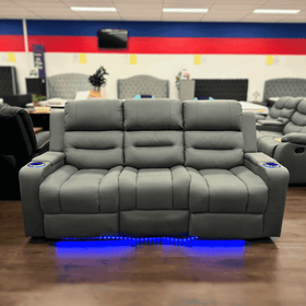 Charcoal three seater recliner sofa with cup holders and blue LED lighting in showroom