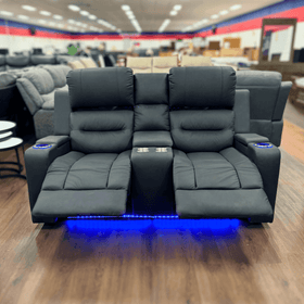 Black two-seater recliner sofa with cup holders, blue LED lighting, and footrests extended