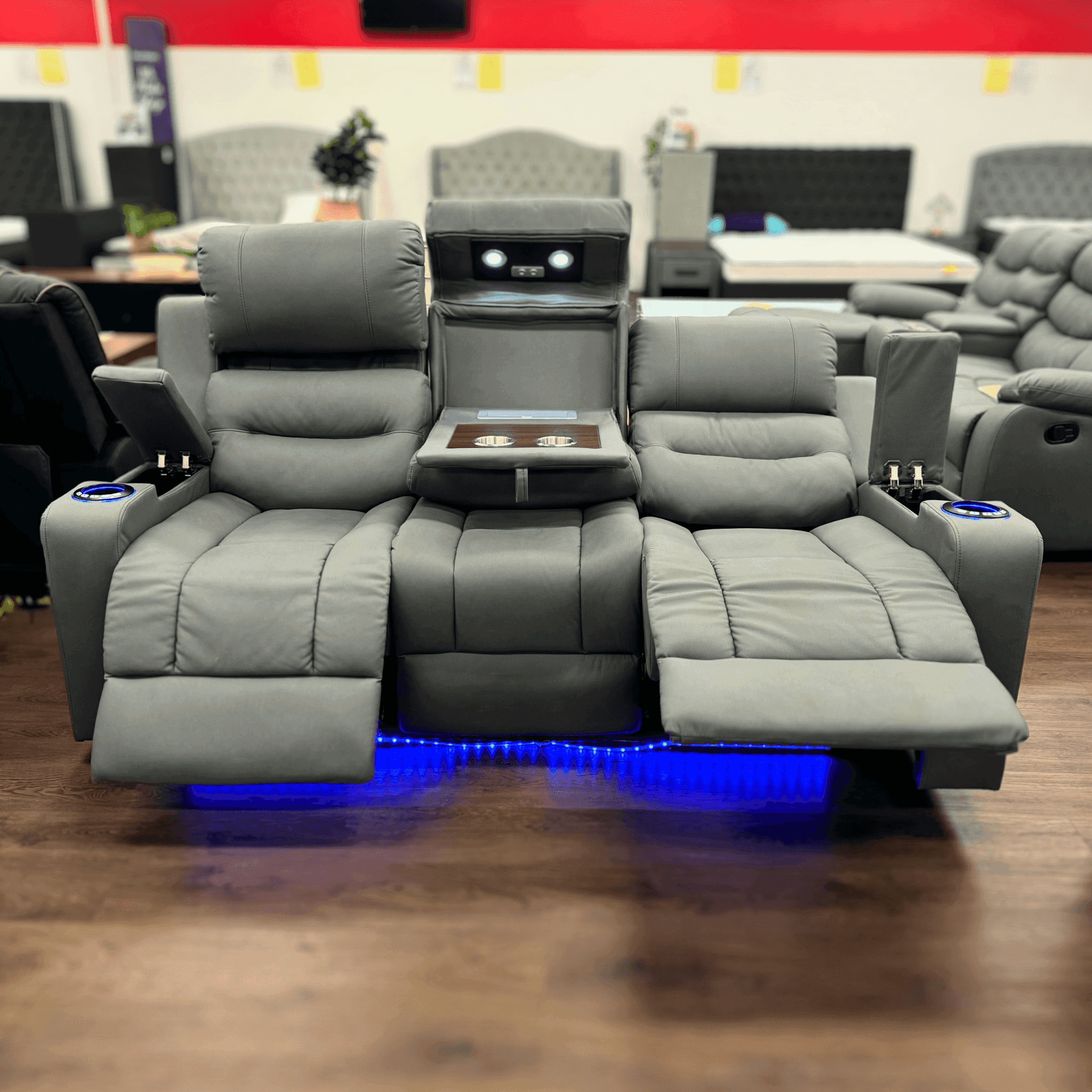 Charcoal three seater recliner lounge with cup holders, LED lighting, and built-in storage