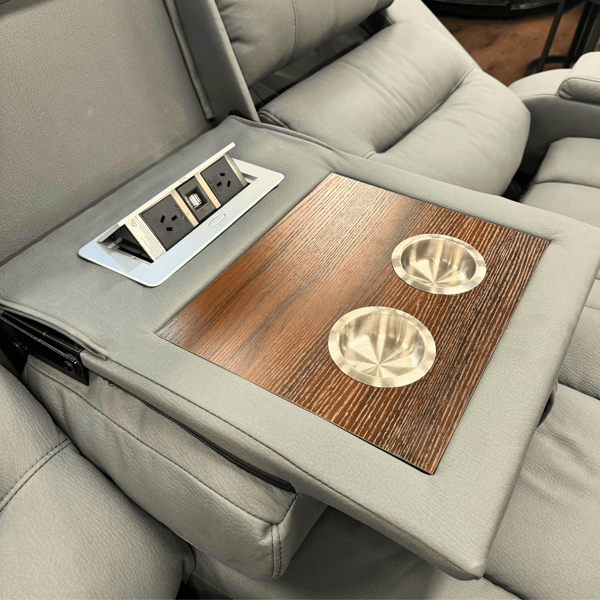 Charcoal recliner sofa with wood tray, built-in cup holders, and USB power outlets