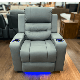 Modern grey single recliner chair with cup holders and blue LED lights on wood flooring