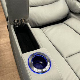 Grey electric recliner chair with illuminated cup holder, control buttons, and storage compartment