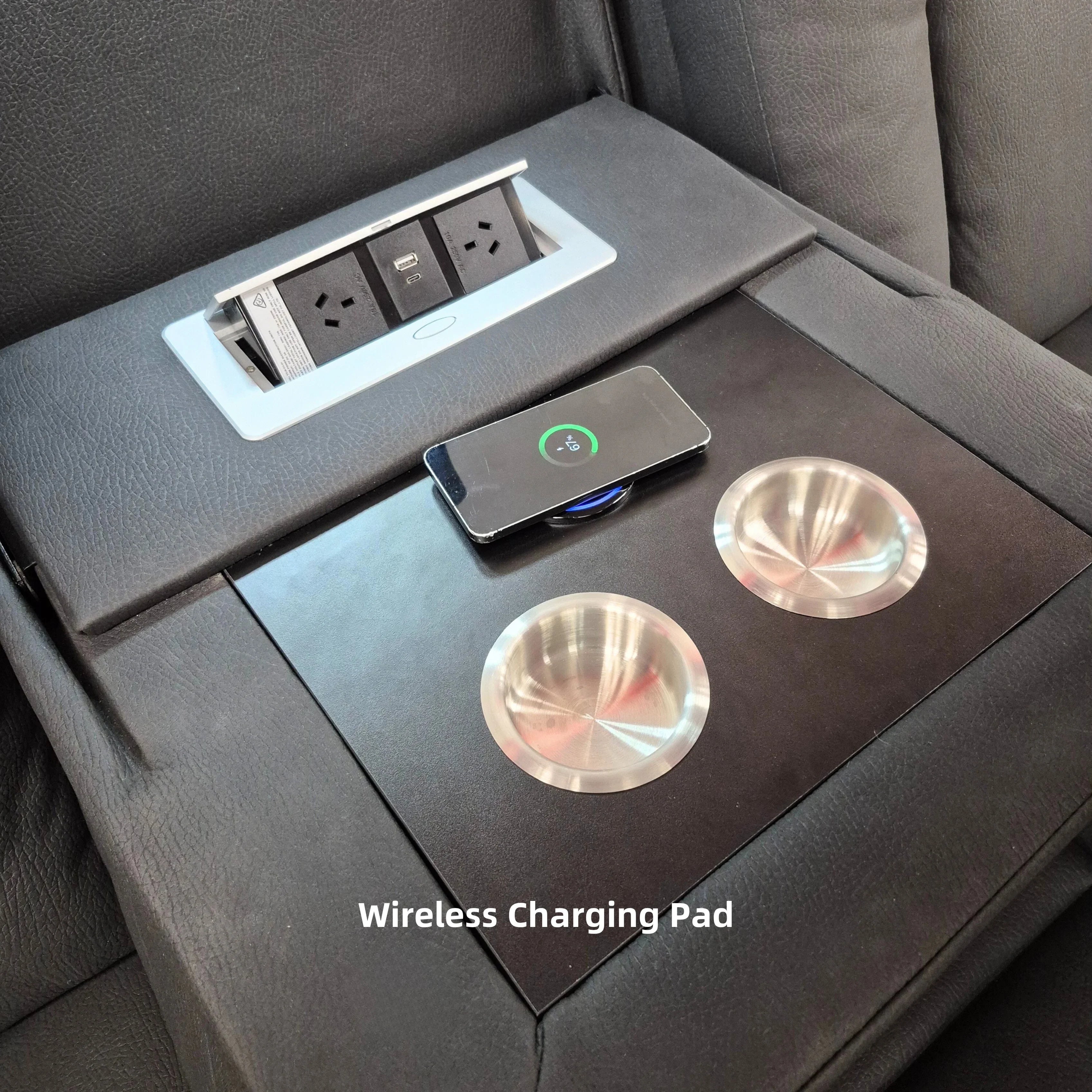 Recliner lounge armrest with wireless charging pad, cup holders, and built-in power outlets