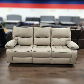 Beige three-seater recliner sofa with plush cushions in a furniture showroom