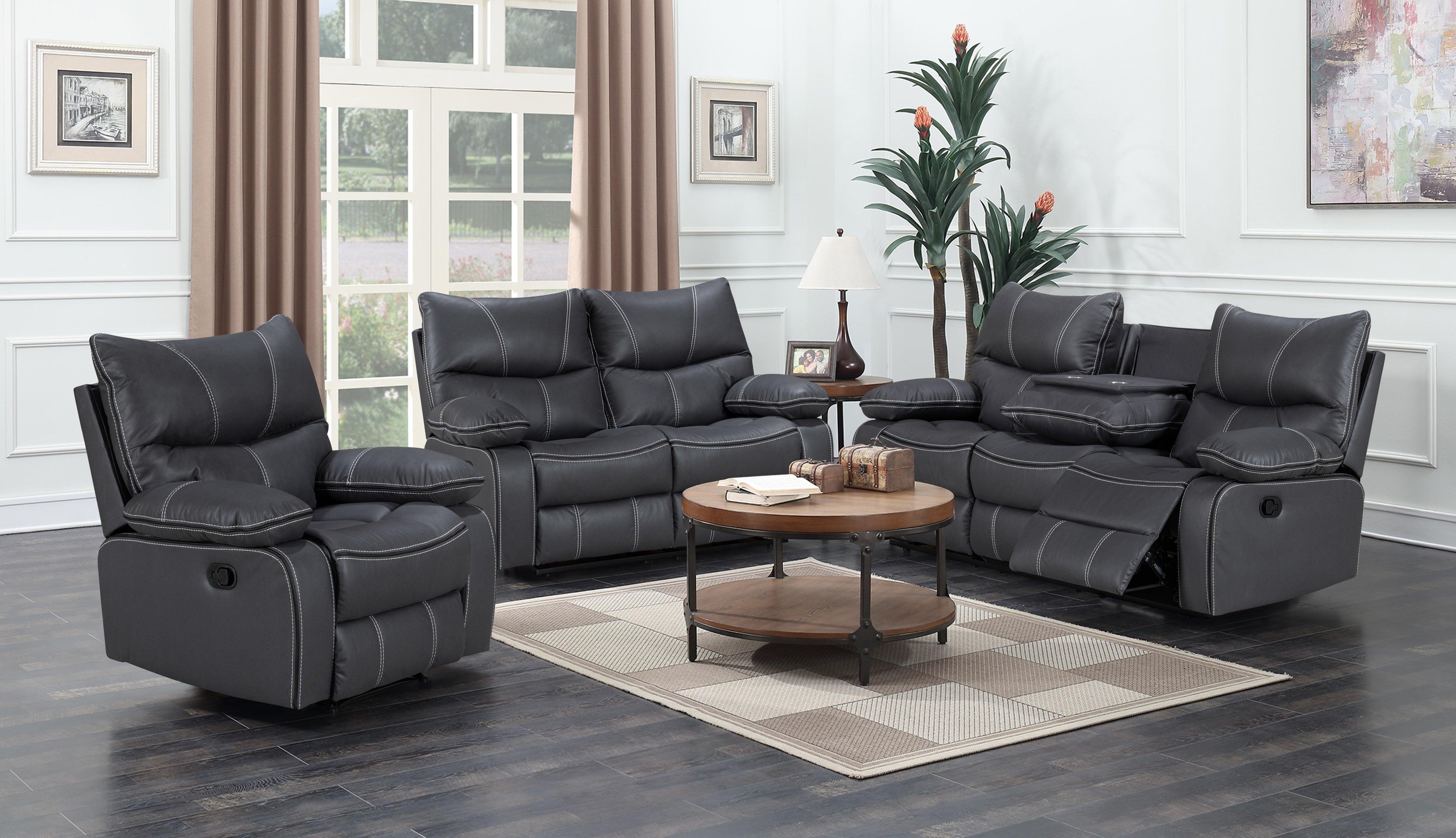 Gray reclining sofa set in a living room with a coffee table and decor.