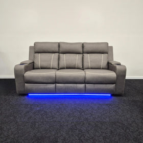 Grey three-seater electric recliner lounge with cup holders and blue LED lighting strip