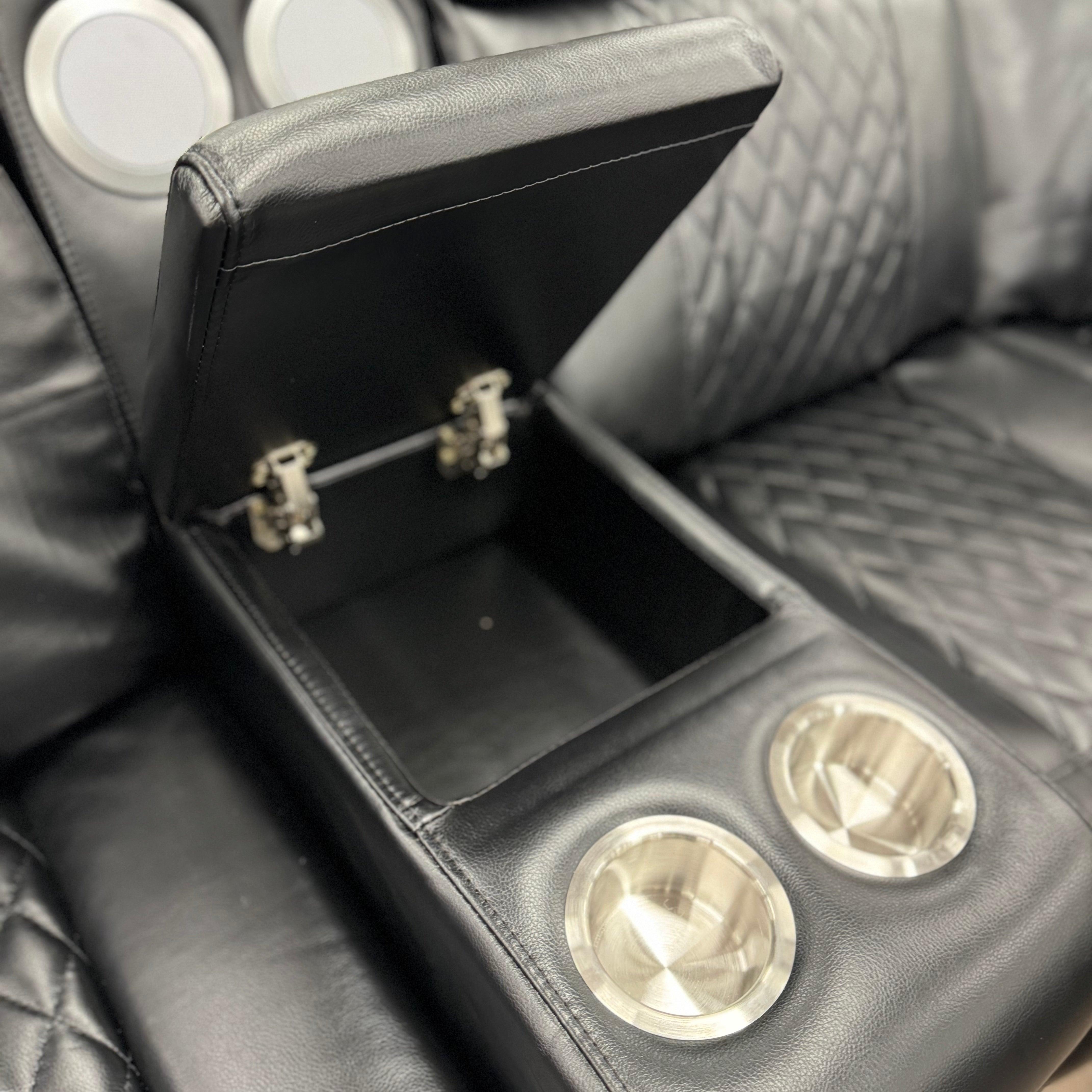 Black leather sofa with storage console and stainless steel cup holders