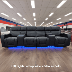 Black recliner sofa with diamond stitching, LED cup holders, and blue LED underlighting in furniture showroom