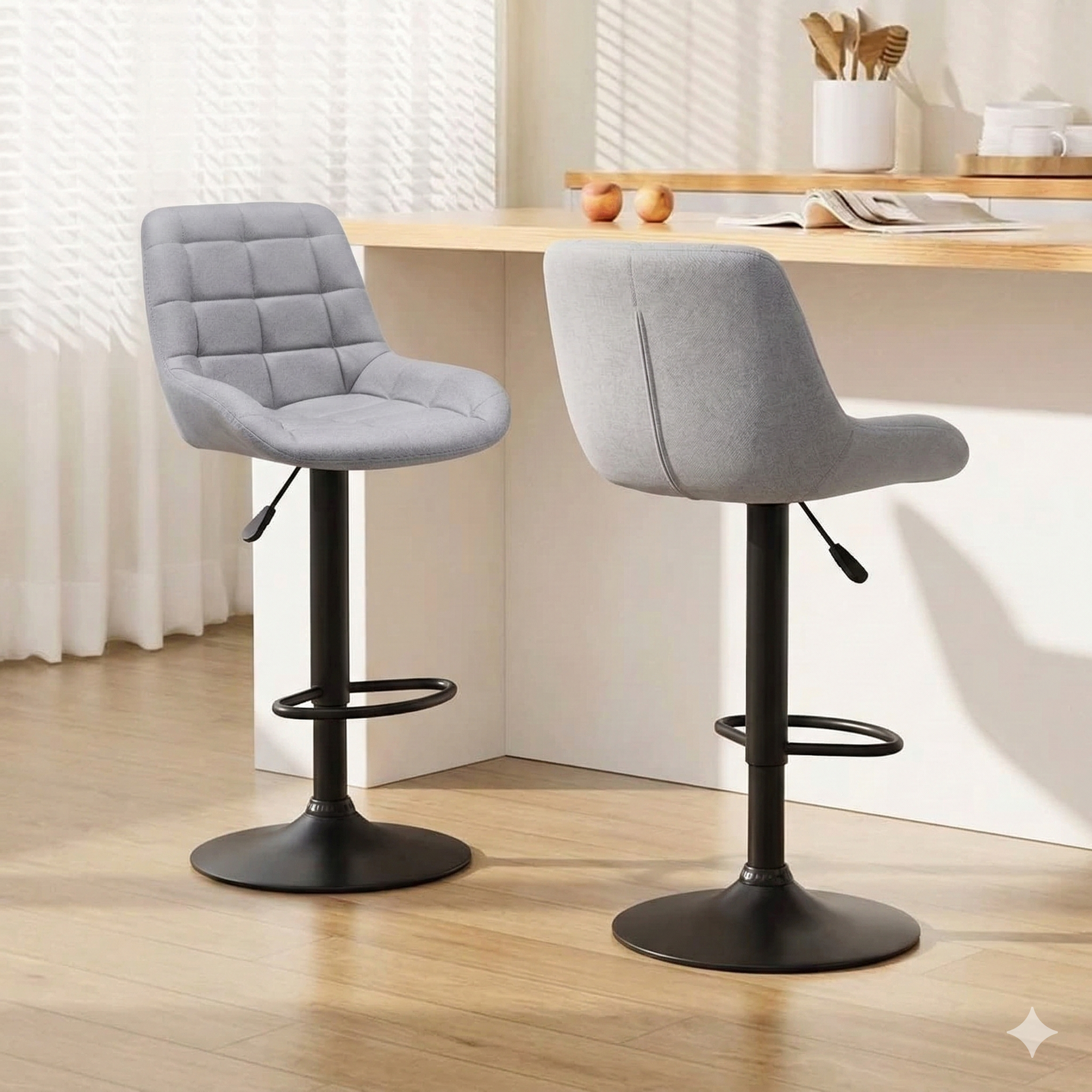 Pair of modern grey bar stools with cushioned seats and black bases in a bright kitchen