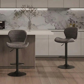 Cambridge Bar Stools in grey fabric with curved backrests and black gas lift bases at a kitchen island