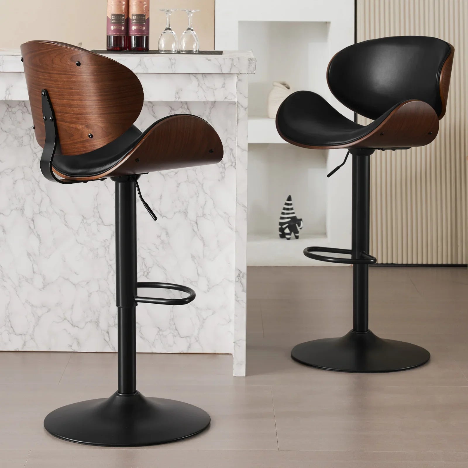 Two bar stools with wooden seats and black bases on a light wood floor.