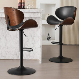 Two bar stools with wooden seats and black metal bases in a modern interior setting.