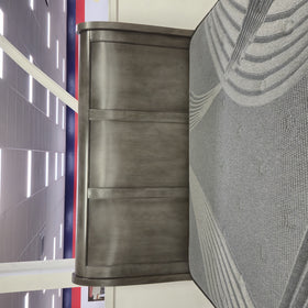 Close-up of the Canada Bed Frame's grey sleigh headboard on The A2Z Furniture showroom floor, showing the panelled wood finish.