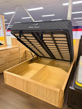 Canberra gas lift bed frame with the mattress platform raised on its gas struts, showing the empty storage cavity below - The A2Z Furniture showroom