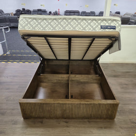 Cannon Gas Lift Bed Frame with the gas lift base raised open for storage access, full side view in walnut finish — The A2Z Furniture showroom. Mattress not included.