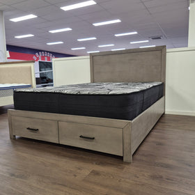 Canyon Bed Frame in grey on The A2Z Furniture showroom floor, side view of the headboard beside a matching two-door bedside cabinet.