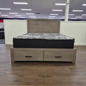 The A2Z Furniture showroom floor display of the Canyon Bed Frame in grey, angled view of the flat-panel headboard, footboard and matching bedside table (mattress shown, not included).