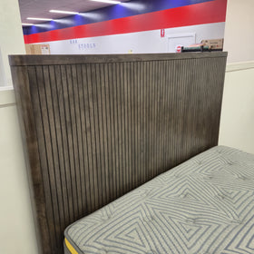 Angled close-up of the Cape Town Bed Frame headboard corner showing dark grey ribbed timber slat detail