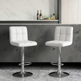 Caribbean Bar Stools in white PU leather with quilted seats and chrome gas lift bases at a home bar