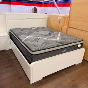 Carinda white gloss gas lift bed frame with curved headboard and footboard on the showroom floor at The A2Z Furniture, shown with a Sleep Serenity mattress (mattress not included)