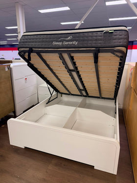 Carinda white gloss gas lift bed frame with the base raised showing the slatted lift mechanism and divided under-bed storage cavity - The A2Z Furniture showroom