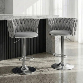 Casablanca Bar Stools in grey velvet with woven backrests and chrome gas lift bases at a stone bar