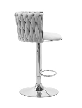 Modern grey velvet bar stool with tufted backrest and chrome base, side view