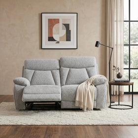 Baker 2 seater recliner lounge in light grey fabric with one footrest extended, styled in a warm neutral living room