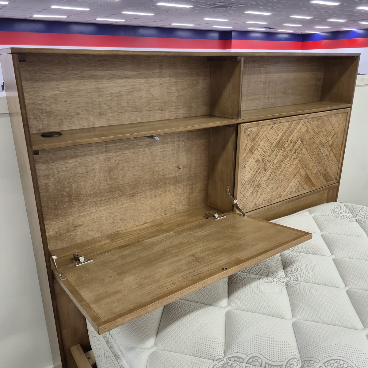 Cleveland Bookcase Bed Frame headboard with a hinged parquet door opened, showing the concealed storage compartment and open shelf cubbies, on display in The A2Z Furniture showroom. Mattress shown is not included.