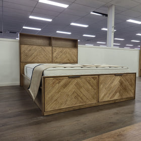 Angled view of the Cleveland Bookcase Bed Frame in a light natural timber finish on the floor at The A2Z Furniture showroom. Mattress shown is not included.