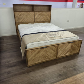 Cleveland Bookcase Bed Frame in a light natural timber finish on display in The A2Z Furniture showroom, side view showing the bookcase headboard and low base. Mattress shown is not included.