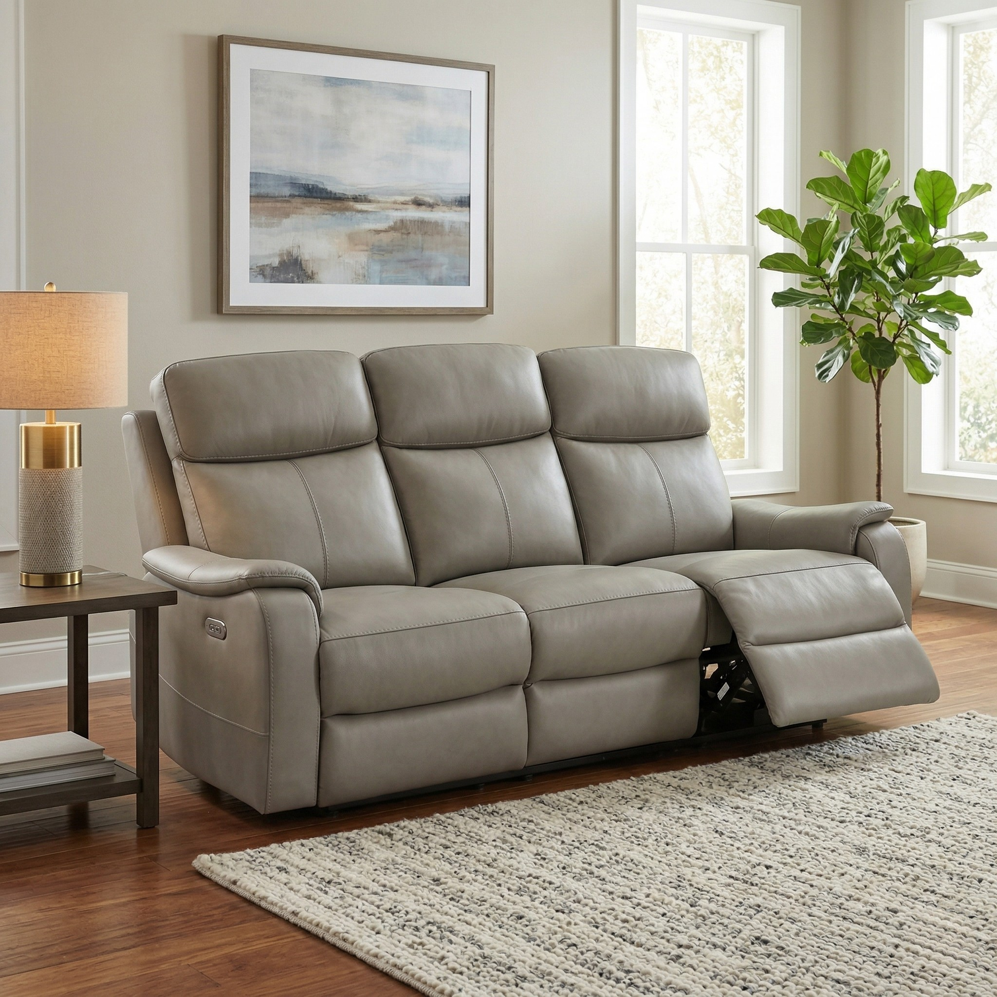 Concord 3 Seater Leather Electric Recliner Lounge in grey leather with plush cushioning, shown with one seat reclined, placed in a bright living room setting.