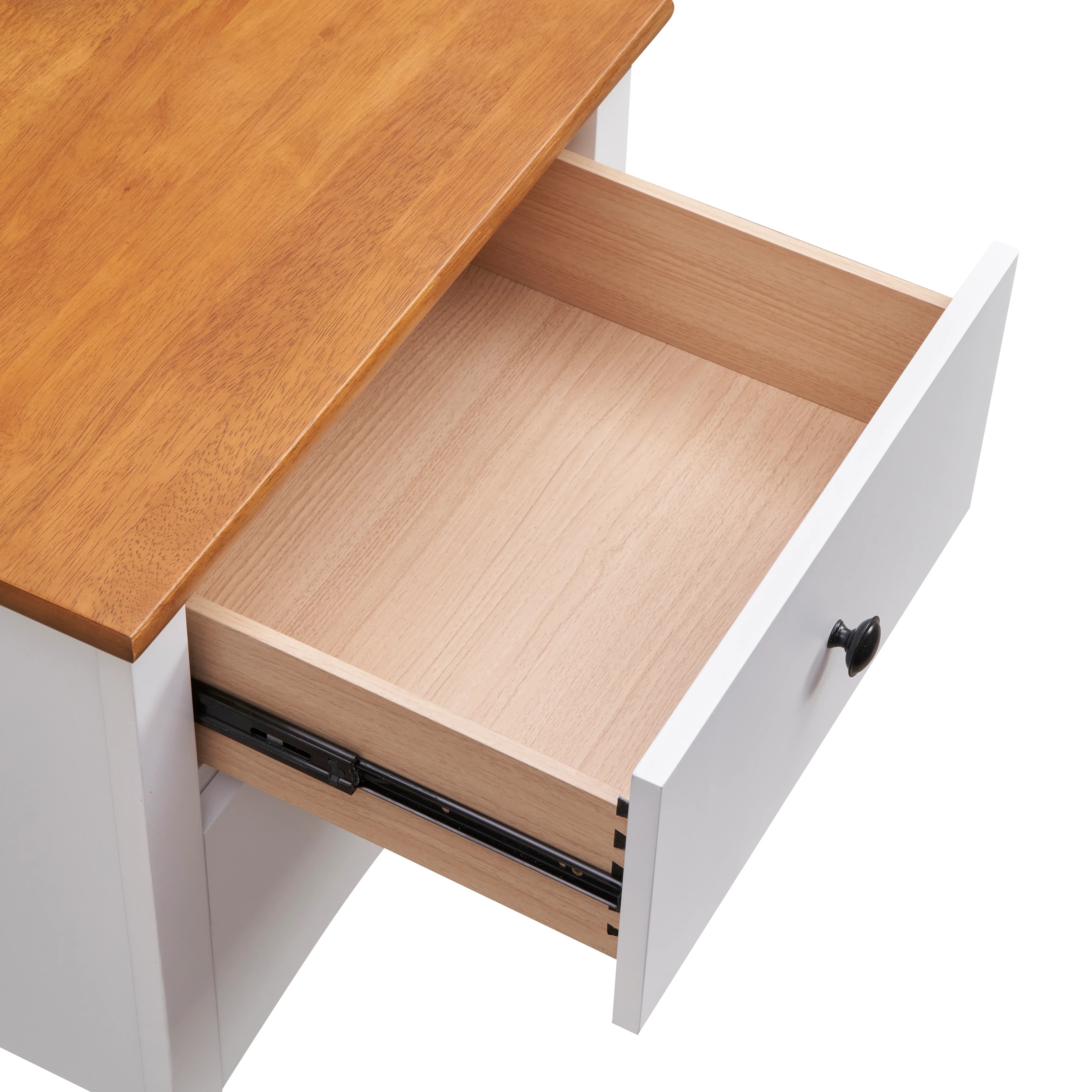 Open white wooden drawer with black knob and natural wood top, close-up view