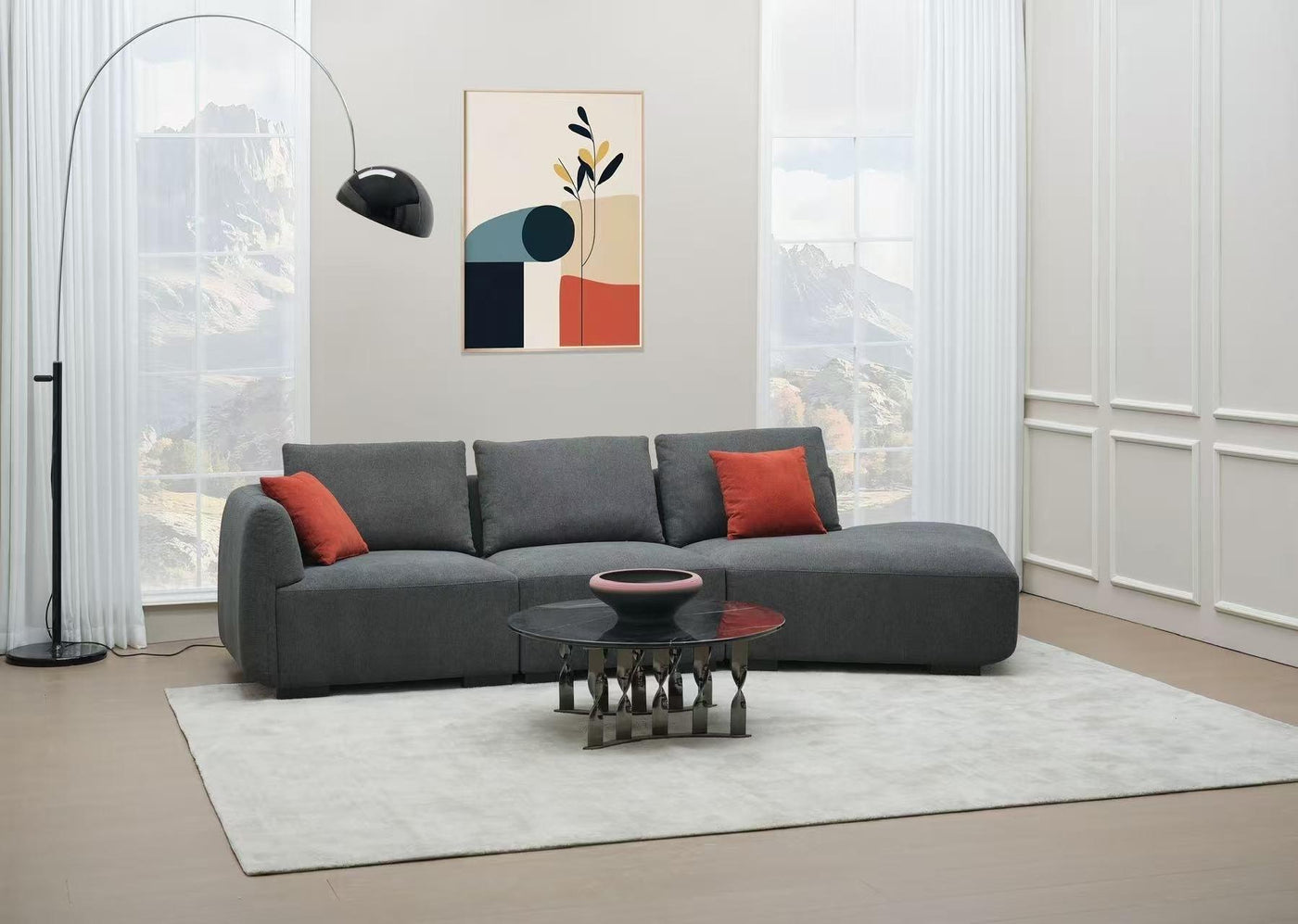 Dark grey modular sofa styled with warm terracotta cushions, a light neutral rug and modern wall art for a balanced grey sofa colour scheme.
