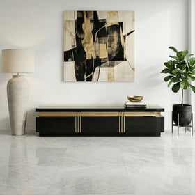 Modern interior with a black and gold TV unit, an abstract painting, and a lamp.