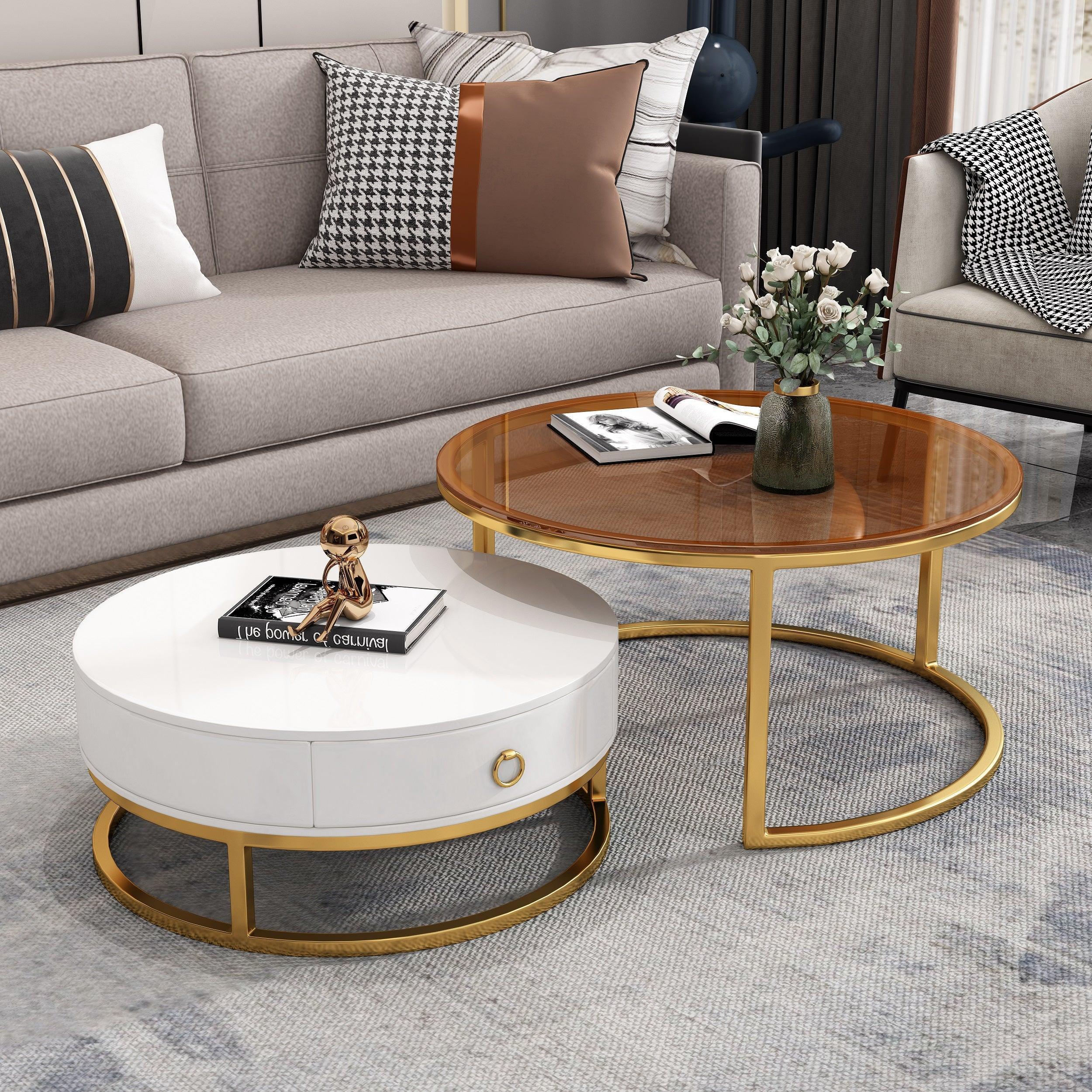 Image of The A2Z Furniture's Dodo Coffee Table set in white with gold accents and gold tempered glass. The set includes a larger round table and a smaller nesting table with a storage drawer