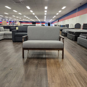 Donald 2 Seater Fabric Sofa in light grey with a dark timber frame and open timber armrests, photographed front-on in The A2Z Furniture showroom