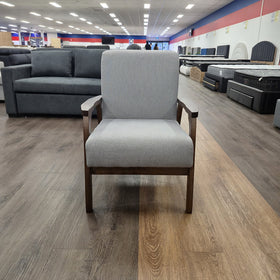 Donald Arm Chair in light grey with a dark timber frame and open timber armrests, photographed front-on in The A2Z Furniture showroom