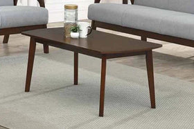 Wooden coffee table in a living room setting with gray sofa and rug.